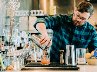 Bartender at Annette pours creative cocktail in Aurora Colorado