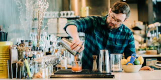 Bartender at Annette pours creative cocktail in Aurora Colorado