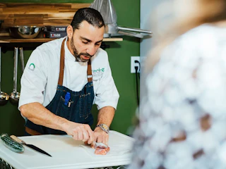Chef and Co-Owner at Create Cooking School, Diego, prep food for a class in Aurora Colorado